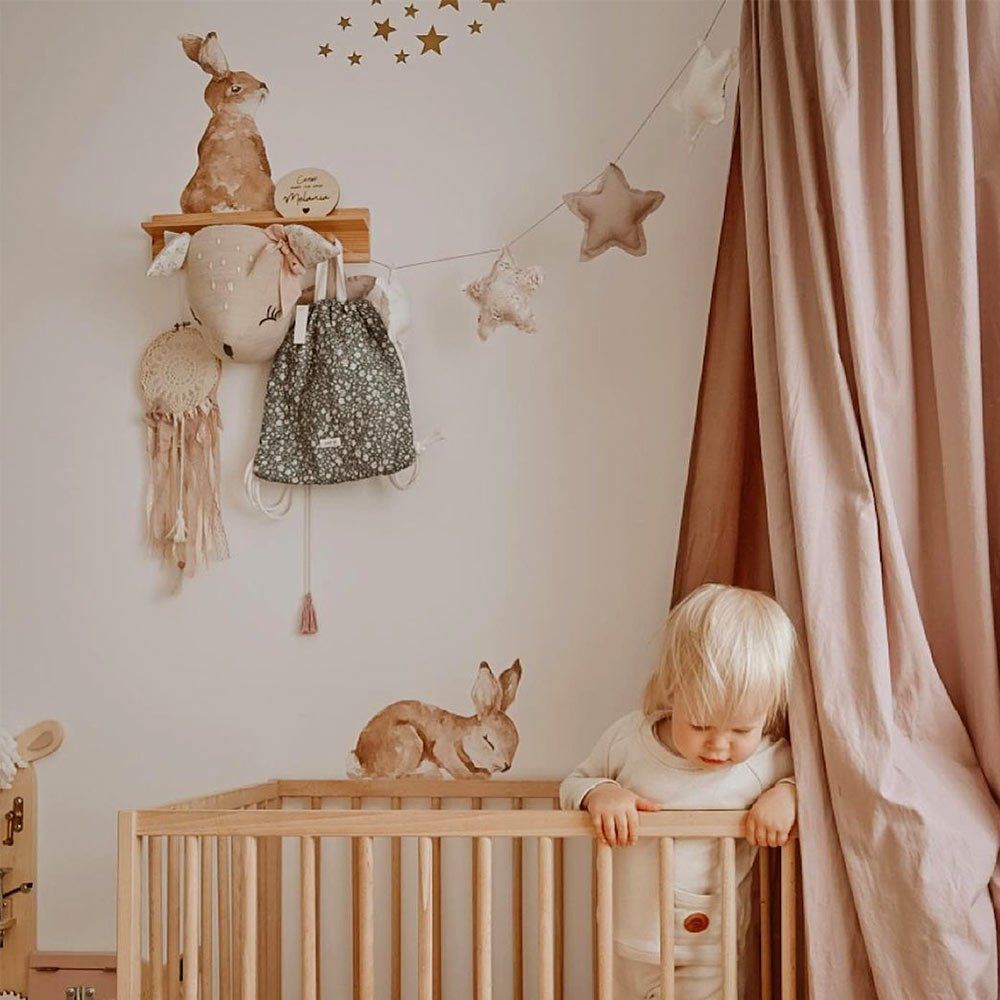Dekornik muursticker Happy Rabbits Wonderland Set met 7 vrolijke konijntjes in zachte tinten op een witte kinderkamermuur