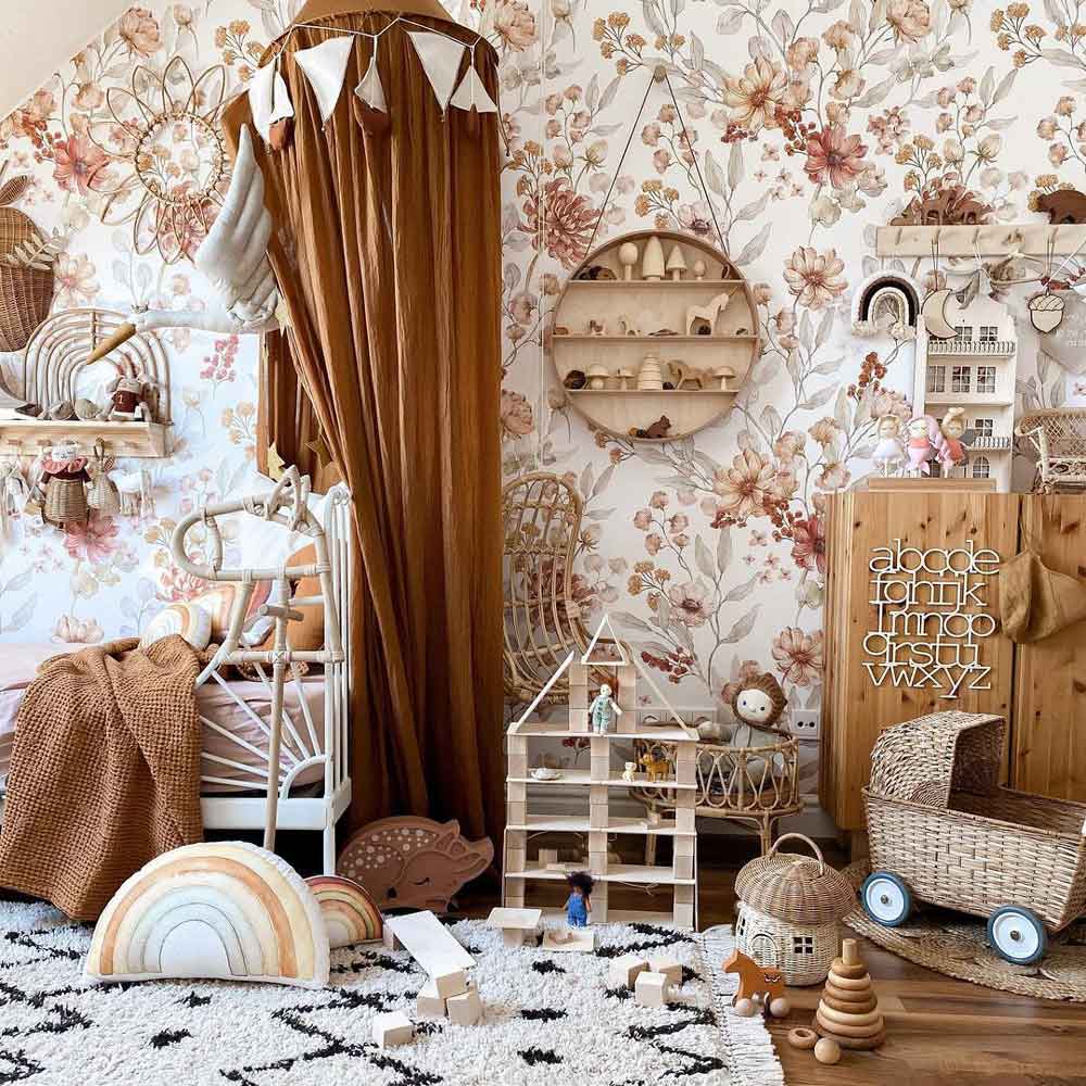 Dekornik Behang Autumn Meadow White — Een licht behang met een herfstig weidemotief van grassprieten, bladeren en kleine diertjes op een witte achtergrond, perfect voor een rustige, natuurlijke kinderkamer. Sfeerbeeld van het behang in een ingerichte kinderkamer.